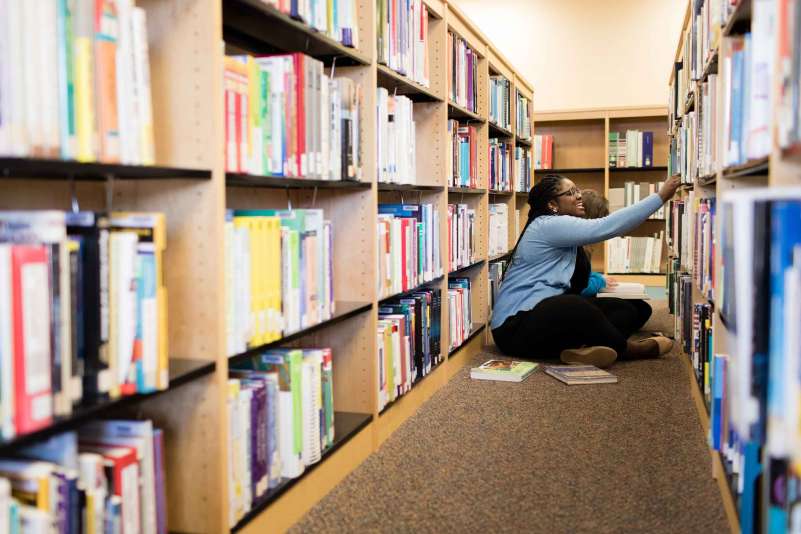 Students in the library searching for books