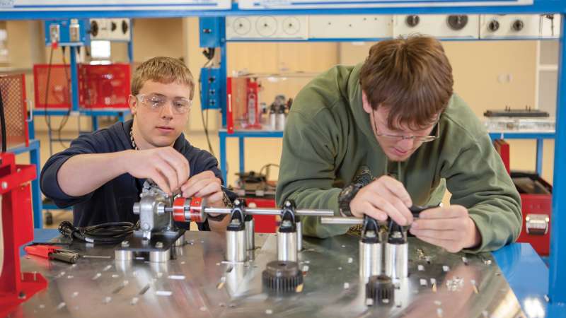 Two Electrical & Instrumentation Apprenticeship students sit together working on a project