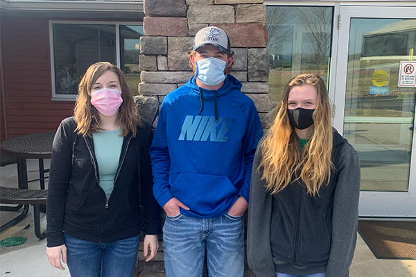 Victoria Leitza, Jaylen Leonhard, and Autumn Salzwedel stand side by side at NTC’s Agriculture Center of Excellence.