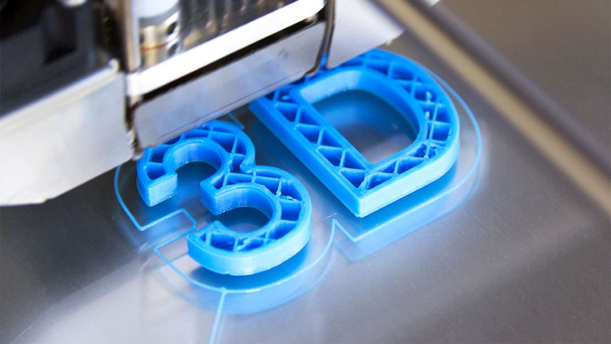 A 3D printer is printing out a mold that says 3D