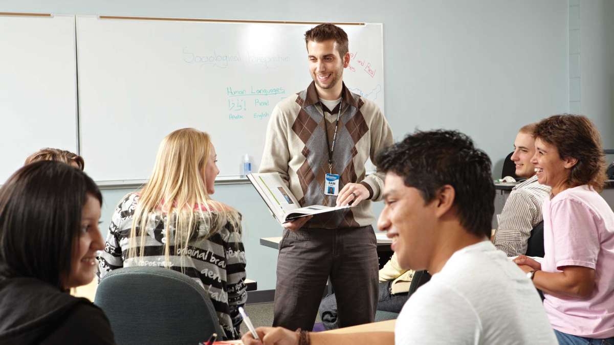 An instructor stands in front of a class teaching