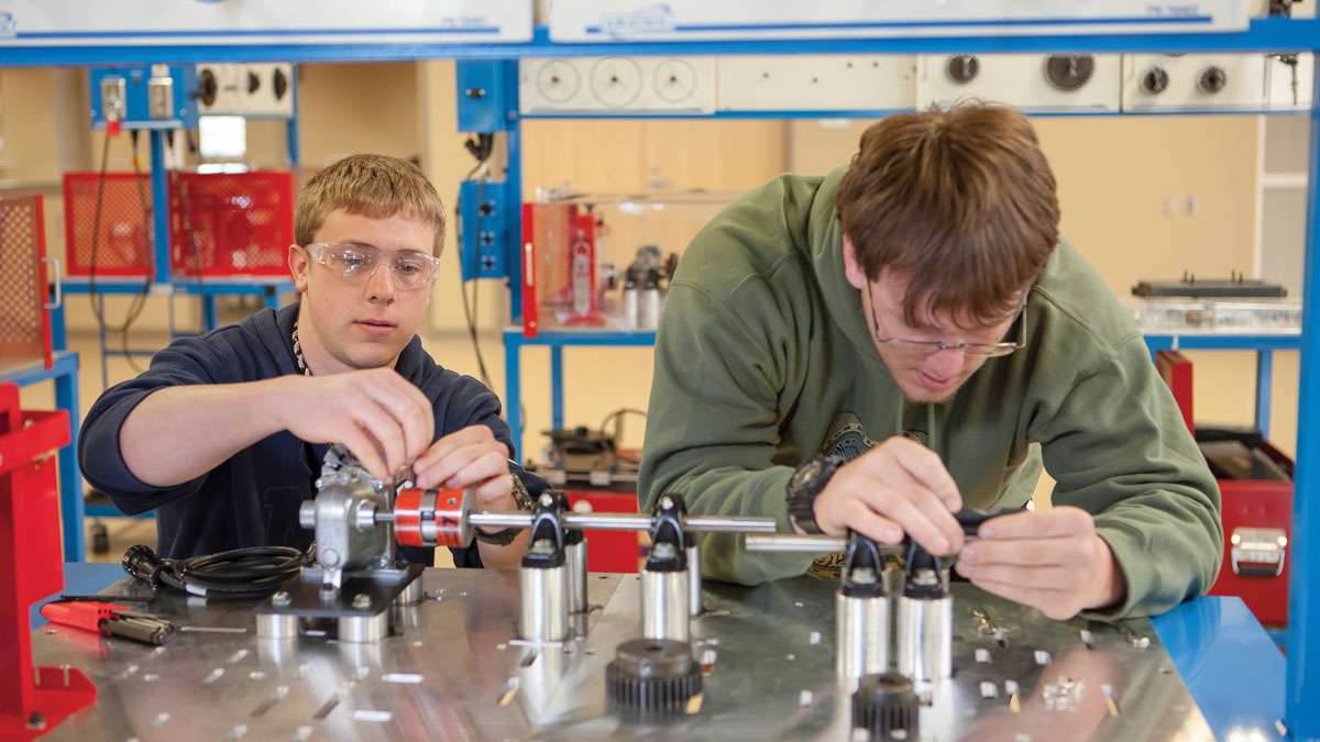 Two Electrical & Instrumentation Apprenticeship students sit together working on a project