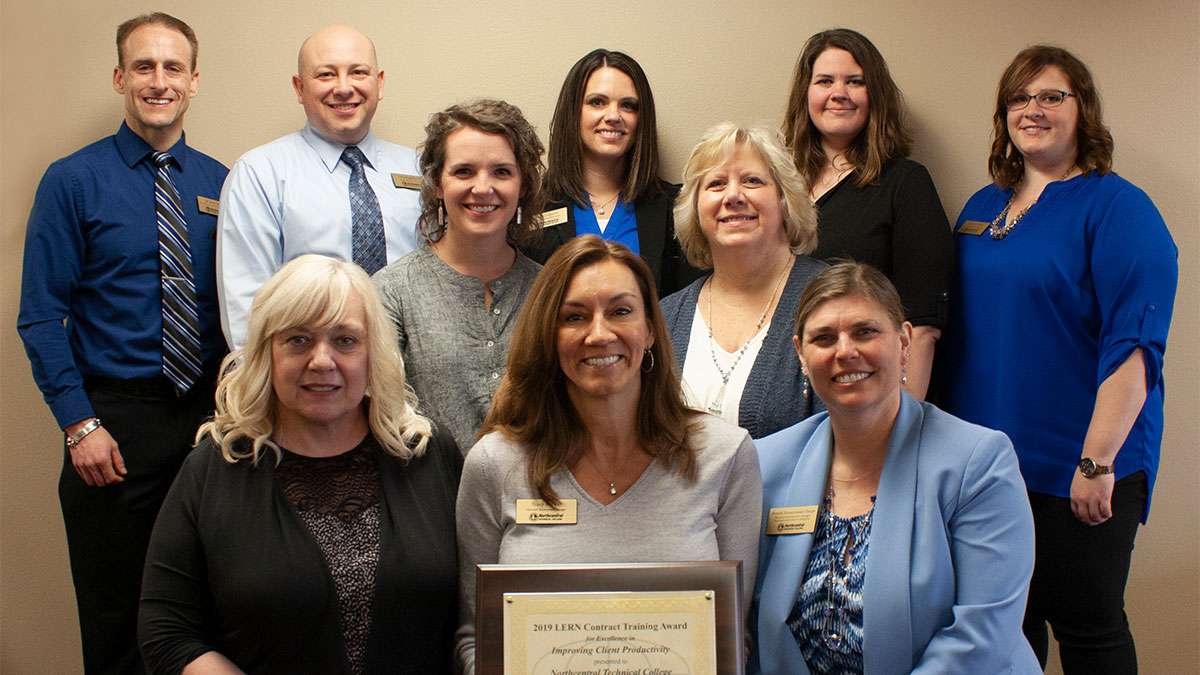 The Business and Industry team stand together holding up the 2019 LERN Contract Training Award for Excellence in Improving Client Productivity