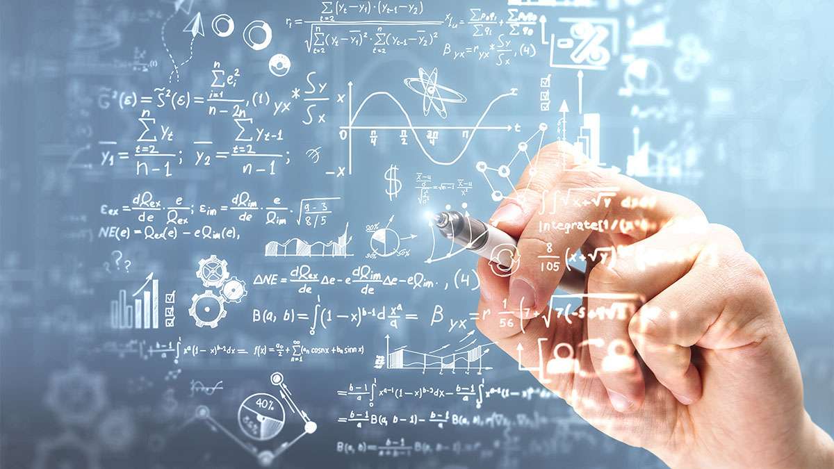 A mathematician is writing complex math equations 