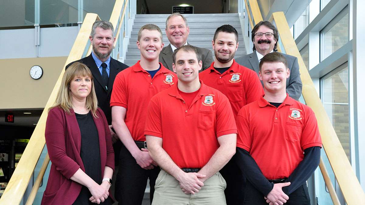 Wausau Area Law Enforcement Academy Graduates stand with their instructors on a staircase