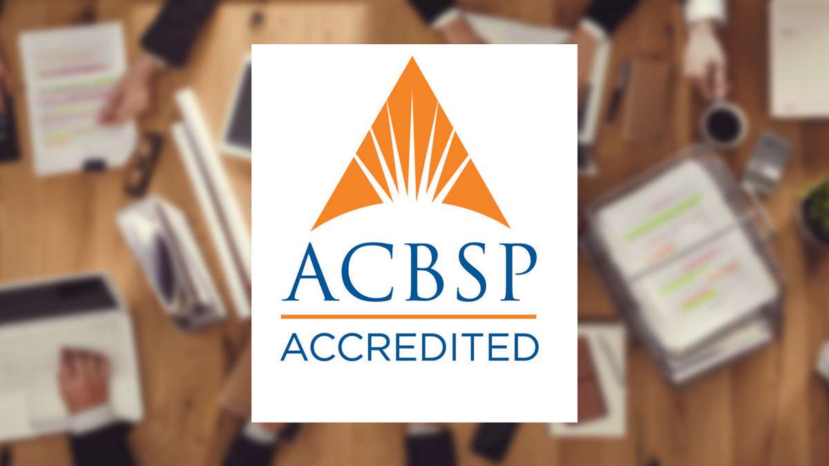 ACBSP Accredited branding logo overlayed on top of a background focusing on business persons sitting at an office table.