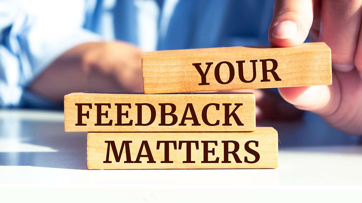 Three wooden blocks that have the words "Your Feedback Matters" etched into them.