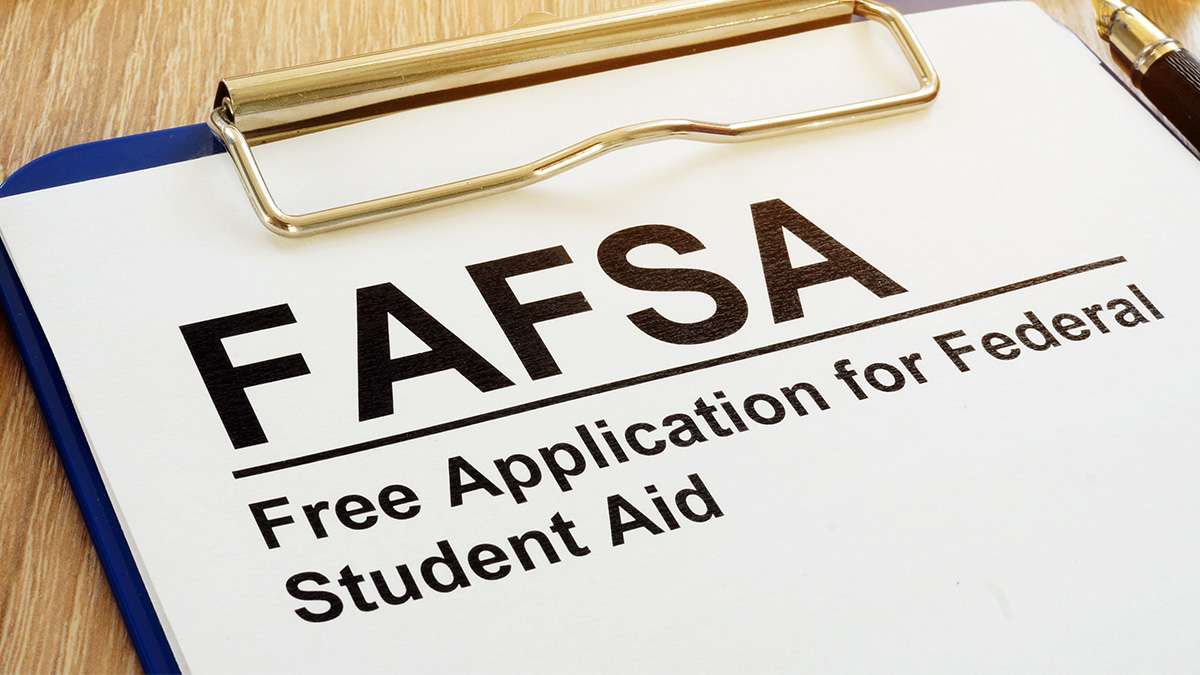 Clipboard with FAFSA form labeled “Free Application for Federal Student Aid.”