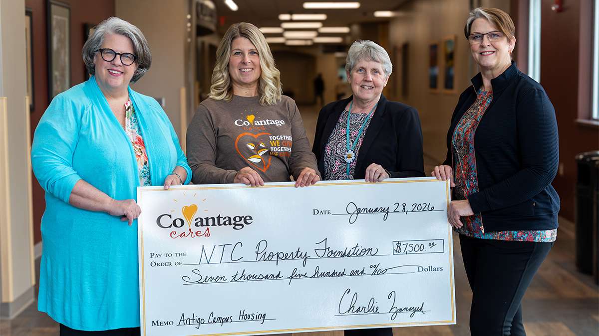 Dr. Jeannie Worden, Stephanie Bartletti, Sheila Rossmiller, and Vicki Jeppesen stand together with oversized check.