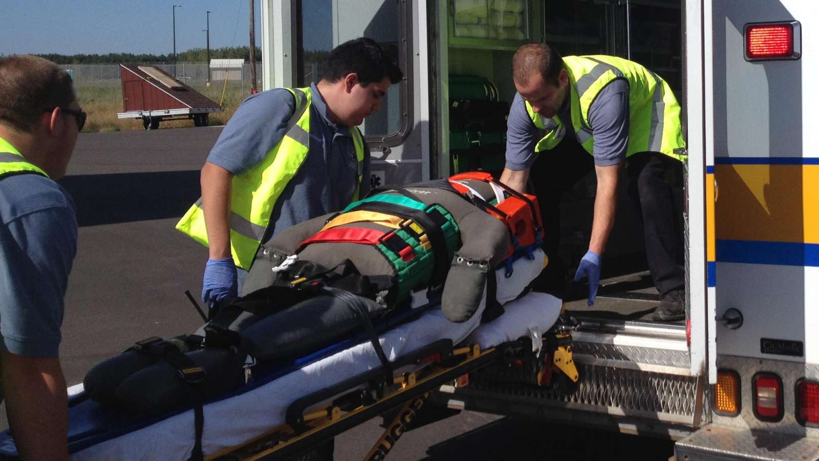 EMS workers loading patient into ambulance