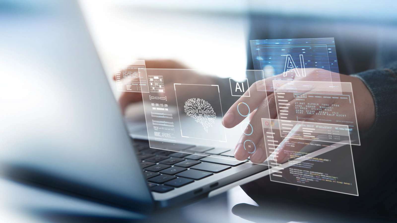 Person typing on a laptop with digital holograms of artificial intelligence (AI) icons, code, neural network graphics, and data interfaces overlaid in the foreground, representing AI technology and machine learning development.