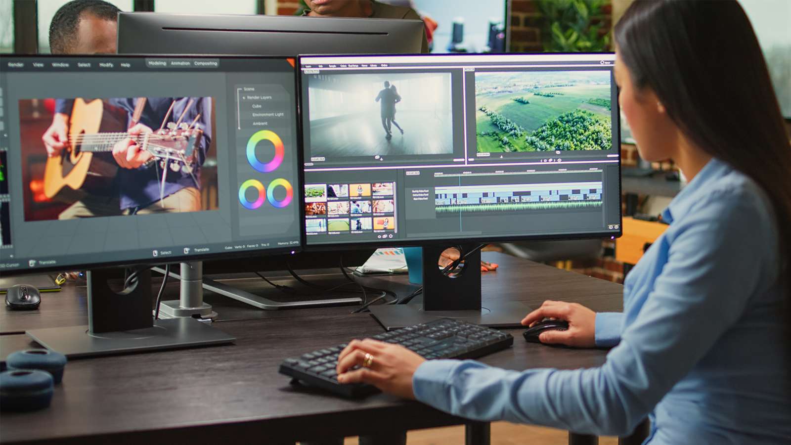Young woman at desk editing video across three monitors showing timeline, color wheels and preview clips.