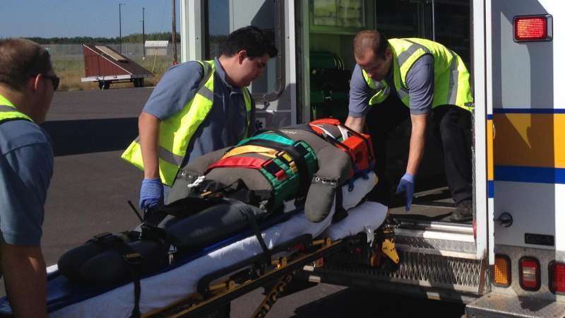EMS workers loading patient into ambulance