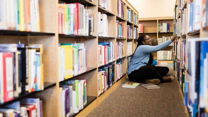 Students in the library searching for books