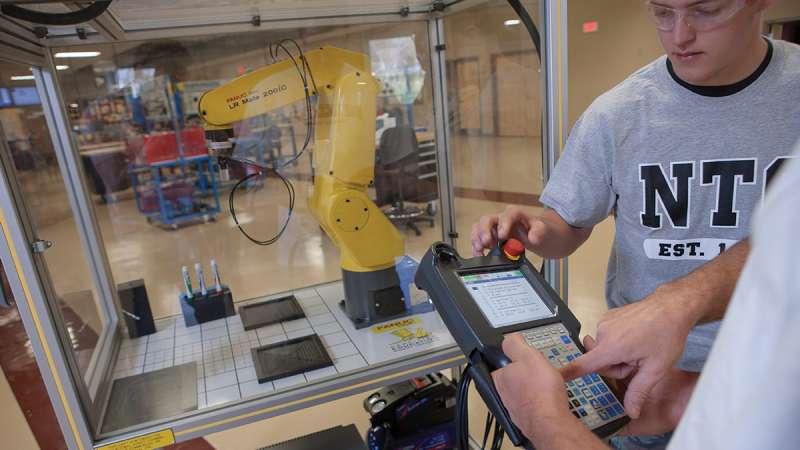 Students working with a robot
