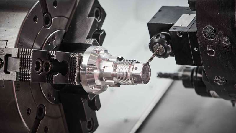 Machine tool equipment bores holes in a part.