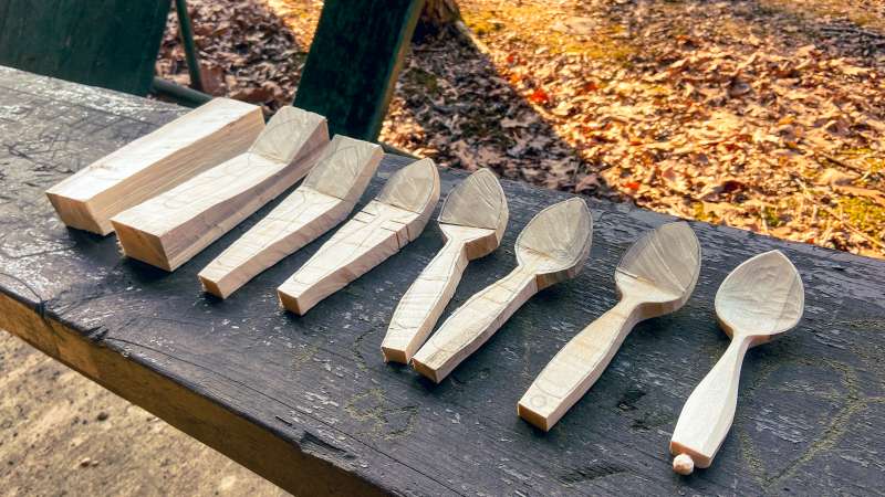 The process of carving a wooden spoon shown in eight stages