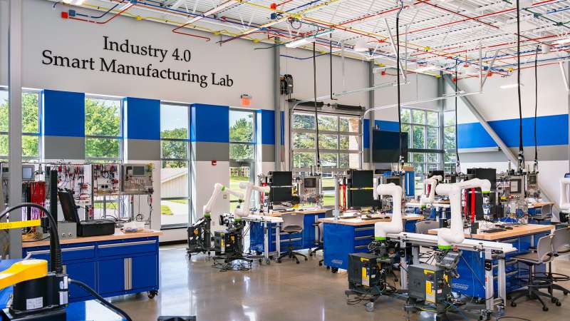 A wide view of the Industry 4.0 Smart Manufacturing Lab, showcasing various robotics and workstations.