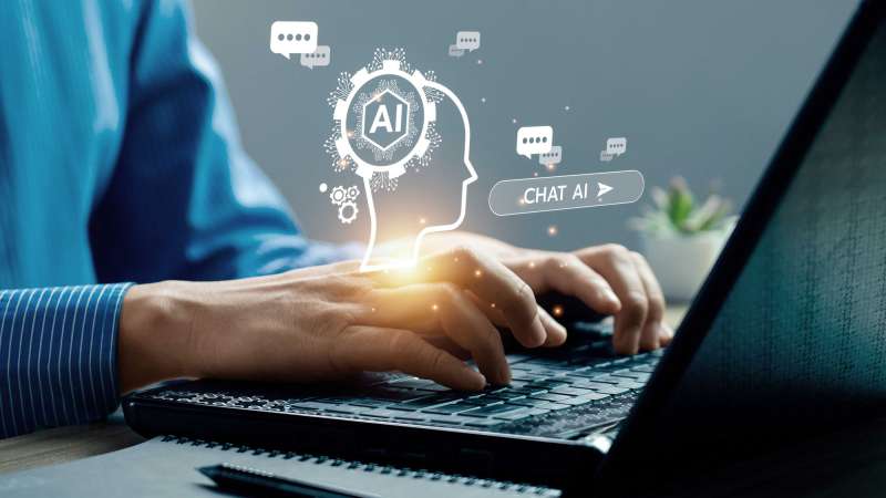 A person typing on a laptop, with various AI graphics overlaid, including chat bubbles and a head silhouette with an AI gear/microchip.