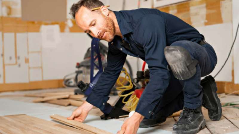 Person working on installing flooring