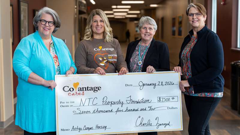 Dr. Jeannie Worden, Stephanie Bartletti, Sheila Rossmiller, and Vicki Jeppesen stand together with oversized check.