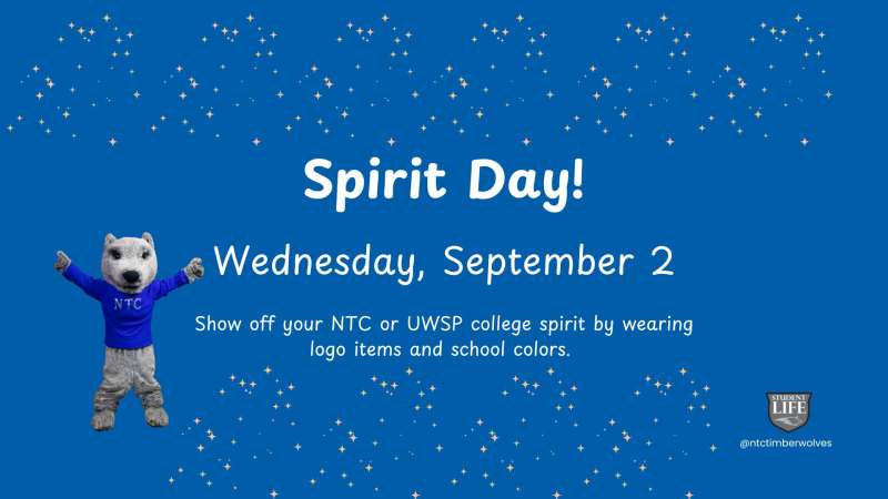 Blue poster reading "Spirit Day! Wednesday, September 2" with waving polar bear mascot in blue sweater, gold confetti speckles and small university logo at corner.