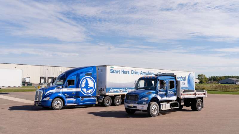 Two NTC training trucks sitting side by side on the paved driving range