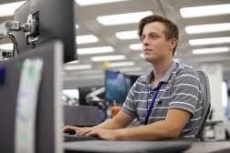 Tanner Champine working at his desk at Sentry Insurance