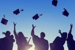 Students throw their graduating hats into the air