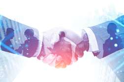 Two people in a suit shake hands