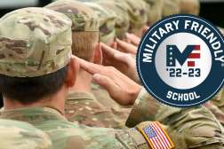 Soldiers dressed in camouflage uniform stand and salute.