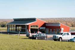 An external view of barns at the Northcentral Technical College Agriculture Center of Excellence.