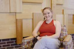 Julianna Bauknecht smiling, while sitting in a chair