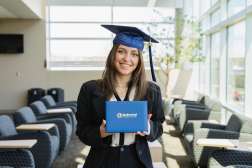 Arianna posing while wearing an NTC graduation cap and holding her diploma.