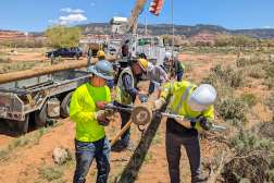 NTC lineman students constructing poles for power lines while working to bring power to the Navajo Nation.
