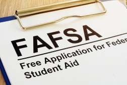 Clipboard with FAFSA form labeled “Free Application for Federal Student Aid.”