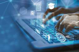 Hands typing on a laptop keyboard, surrounded by glowing white digital education and information icons on a blue background.