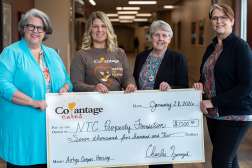 Dr. Jeannie Worden, Stephanie Bartletti, Sheila Rossmiller, and Vicki Jeppesen stand together with oversized check.