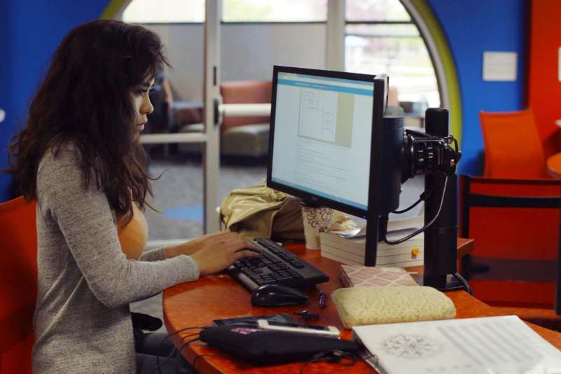 Student working on a computer in the NTC iTEC