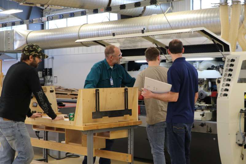 Wood Technology students learning about a machine