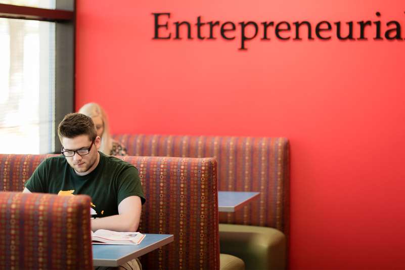 Students studying in booths just outside the Information Technology Entrepreneurial Center (iTEC)