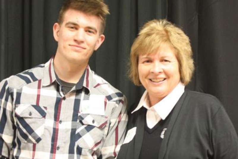 Lori Weyers Stands next to a student at the donors reception