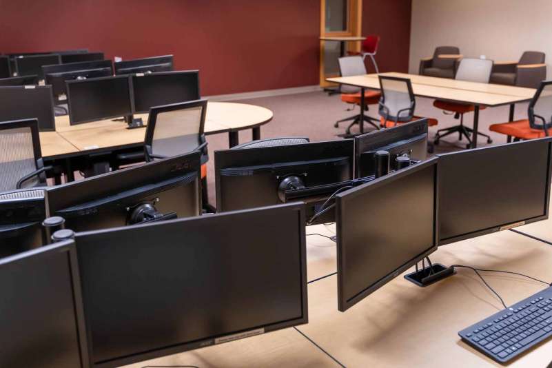 Several desktop computers at tables in the Community Technology Center