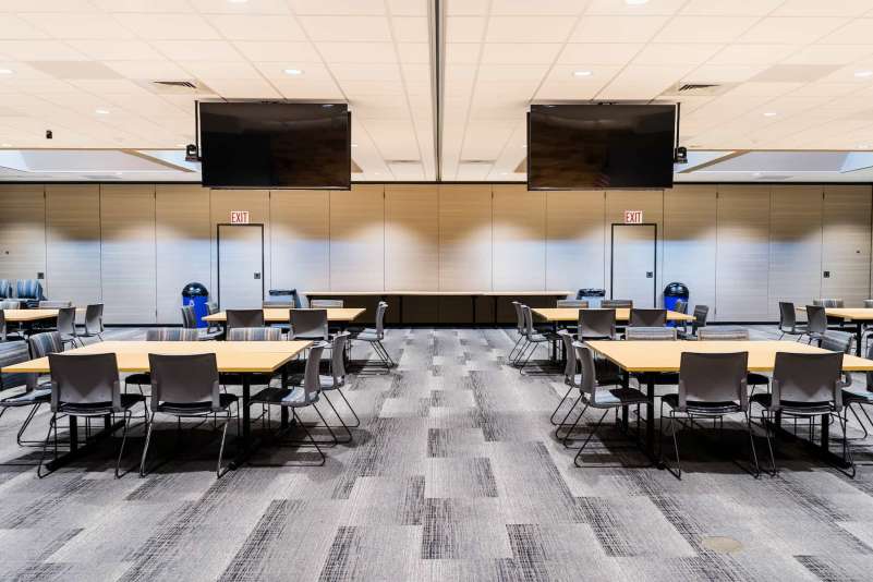 The spacious Community Training Room features skylight windows, numerous tables and chairs, and an optional divider wall.