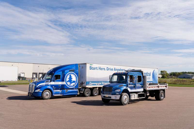 Two NTC training trucks sitting side by side on the paved driving range