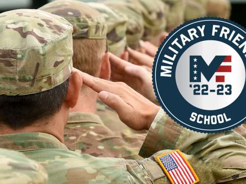 Soldiers dressed in camouflage uniform stand and salute.