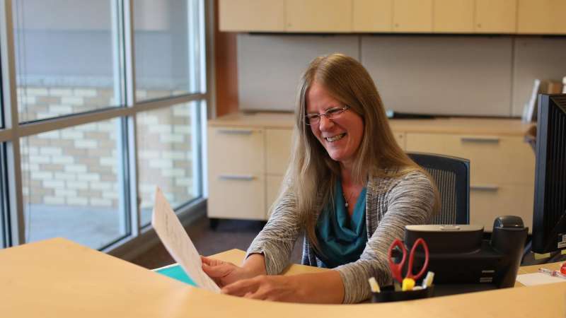 Businesswoman sorting papers at her desk