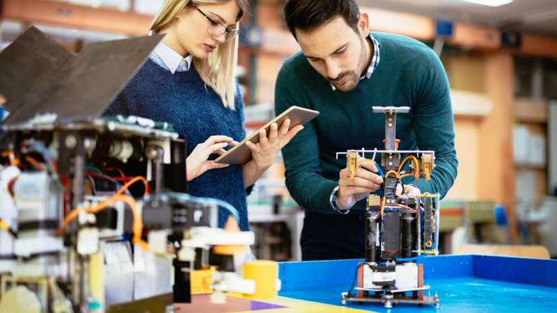 Engineers working on a robot