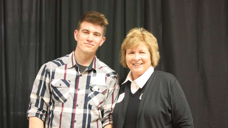 Lori Weyers gives a student the Lori Weyers Presidential Scholarship