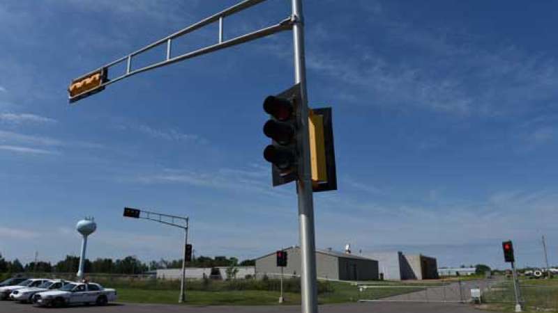 A view of a DOT regulated traffic standards area, including traffic lights at an intersection.